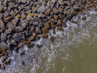 Beach wave hit on rock seaside view from top