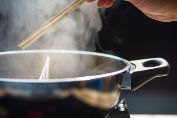 Fototapeta premium Shabu-shabu is a Japanese nabemono hotpot dish of thinly sliced meat and vegetables boiled in water. The term is onomatopoeic, derived from the sound emitted when the ingredients are stirred.