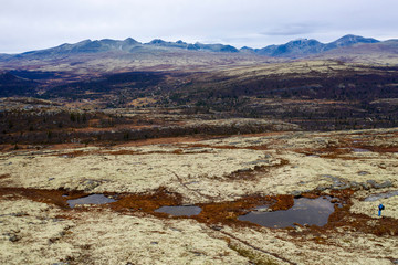 Man in blue clothes in beautiful mountain scenery landscape..Aerial, mountain, nature, hiking, photography concept.
