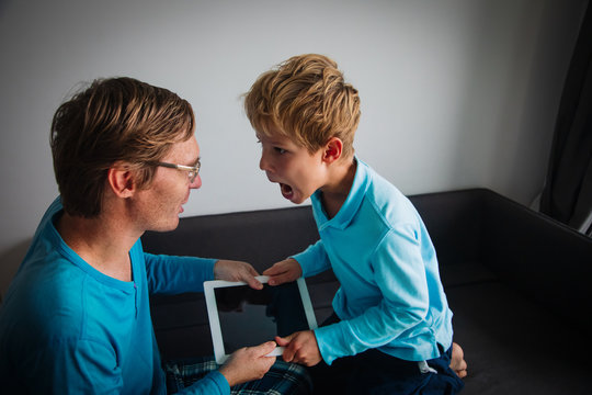 Internet Addiction- Father Taking Touch Pad From Angry Child