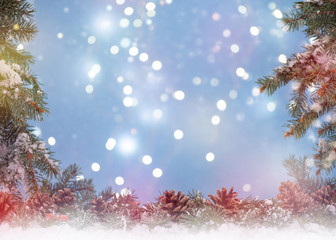 Christmas background. Fir branches on snow background bokeh light