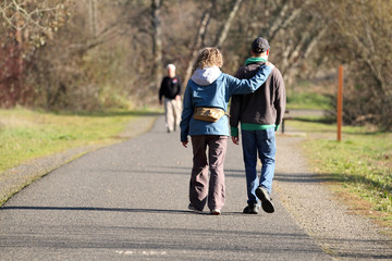 Fototapeta premium Mature couple taking a walk in a park on a sunny day.