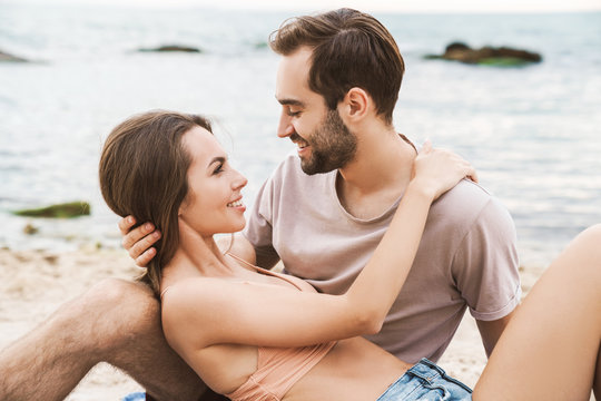 Photo of romantic beautiful couple hugging and smiling at each other