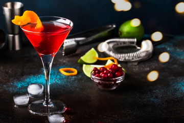 Classic alcoholic cocktail cosmopolitan with vodka, liqueur, cranberry juice, lime, ice and orange...