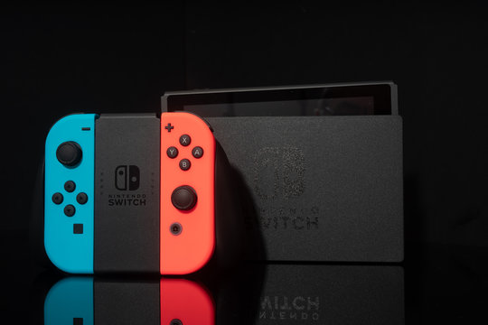 Nintendo Switch video game console developed by Nintendo, released on March 3, 2017 on a black background. Germany, Berlin - June 30, 2019: Nintendo Switch Joy-con controller on a white background