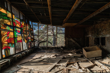 Large broken windows of abandoned building