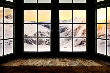 Table top with big window background and beautiful snowy winter landscape outside. Sunny winter day.