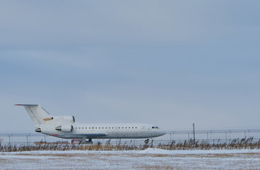 Plane at the airport on the runway in winter. Aircraft winter runway