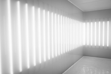 Room with long light bulb on the wall in black and white color