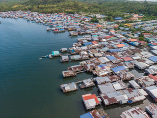 Fototapeta na wymiar Top down aerial view of the local lifestyle traditional water village houses in a small village Beside sea at Kudat, Sabah, Borneo. 