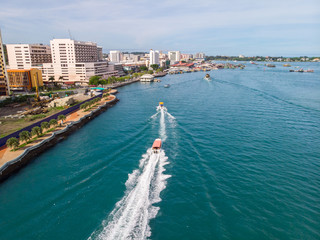 Fototapeta na wymiar Aerial image of tourist speed boat on moving at clear blue sea at Waterfront Kota Kinabalu, Sabah, Malaysia