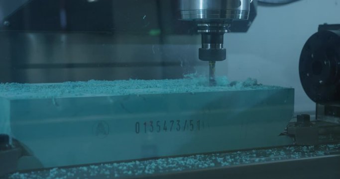 CNC machine router drilling bit spindle begins drilling hole in foam material