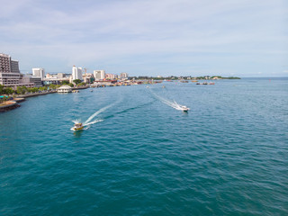 Aerial image of tourist speed boat on moving at clear blue sea at Waterfront Kota Kinabalu, Sabah,...
