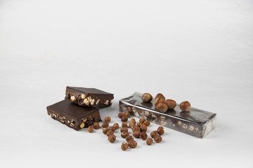 Chocolate and hazelnut nougat on a white background. Copy space. Sweet Christmas. - Image
