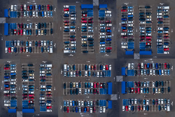 Aerial top view of parking with many cars. Many cars are parked in a parking lot with white markings. Parking places with vehicles pattern.