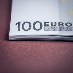 Euro cash on a pink and brown background. Euro Money Banknotes. Euro Money. Euro bill. Place for text.