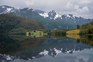Beautiful mountain scenery and reflections in Lake in the western part of Norway. Road trip, holiday, scenery, landscape concept.