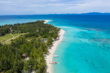 Beautiful white sandy beach tropical island with turquoise sea water and Malay traditional...