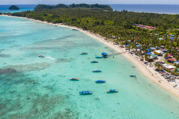 Beautiful white sandy beach tropical island with turquoise sea water and Malay traditional...