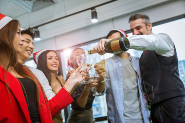 Group of happy young various people having happy new year party at the office.