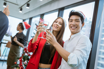 Group of happy young various people having happy new year party at the office.