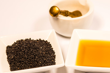 black caraway with black caraway oil and mortar