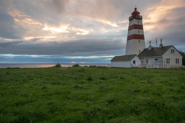 Fototapeta na wymiar Lighthouse in Aalesund/Norway at sunset. Architecture, lighthouse, sky, clouds, sunset, summer.