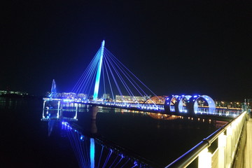 Fototapeta na wymiar Night view of a beautiful scene of bridge over sea water in the evening time.