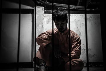 Asian man desperate at the iron prison,prisoner concept,thailand people,Hope to be free,Serious...