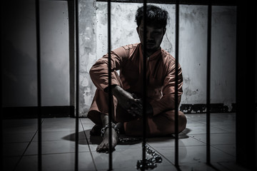 Asian man desperate at the iron prison,prisoner concept,thailand people,Hope to be free,Serious...