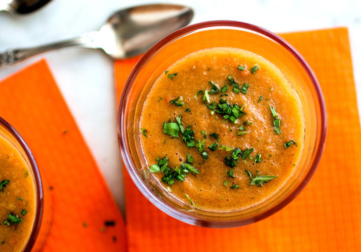 Overhead view of gazpacho garnished with coriander served in bowl