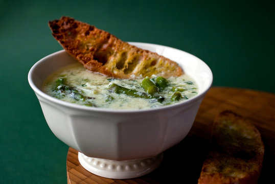 Asparagus soup with green garlic and eggs served with bread