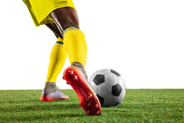 Professional african-american football or soccer player of yellow team in motion isolated on white...