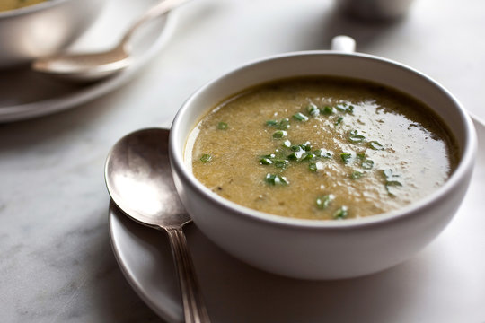 Close up of lettuce and green garlic soup served in bowl