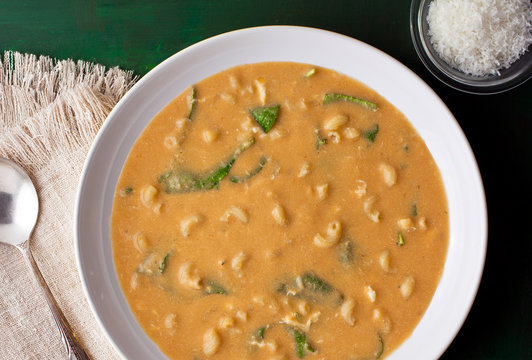 Close up of garlic soup with spinach served in bowl