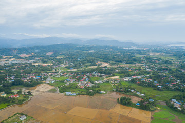 Aerial view of beautiful paddy field surrounding by small town at Penampang, Sabah, Borneo 