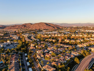 Aerial view of residential modern subdivision luxury house neighborhood during sunset. South California, USA