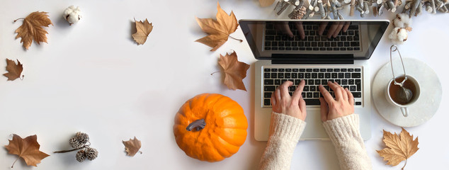 Top view of woman typing laptop in Autumn