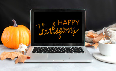 Front view of laptop and blank screen. Happy Thanksgiving text