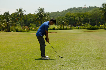 Fototapeta premium Golfer playing golf in beautiful golf course in the evening golf course with sunshine in thailand