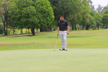 Fototapeta premium Golfer playing golf in beautiful golf course in the evening golf course with sunshine in thailand