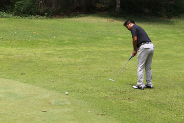 Fototapeta premium Golfer playing golf in beautiful golf course in the evening golf course with sunshine in thailand