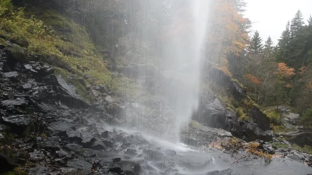 Waterfall in the autumn forest (Massif Central in France)