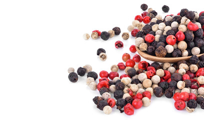 Mix from  kinds of pepper and  spoons isolated on white