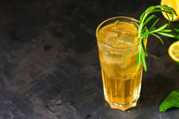lemonade ice in a glass with rosemary (tasty drink, beverage) menu concept. food background. top view. copy space