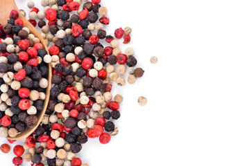 Mix from  kinds of pepper and  spoons isolated on white