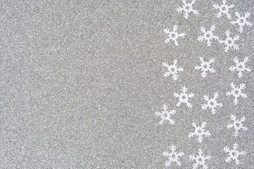 Beautiful Christmas card. White snowflakes on a silver background