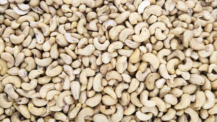 a lot of cashew nuts lying nearby. peeled nuts. snack. For design, market, article, print, recipe, cuisine, cocktail. background