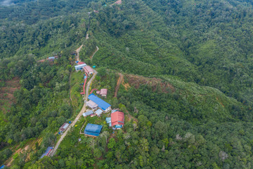 Amazing drone image of beautiful nature deep rainforest jungle with houses at Sabah, Borneo