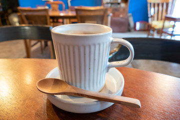Coffee cup on  brown wooden table